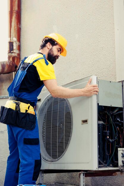 AC technician repairing unit